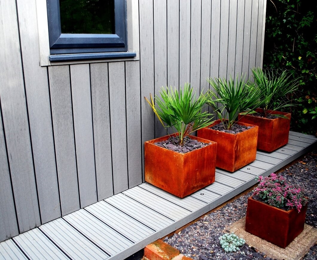 Stone Grey Clad garden room with warm toned natural plants