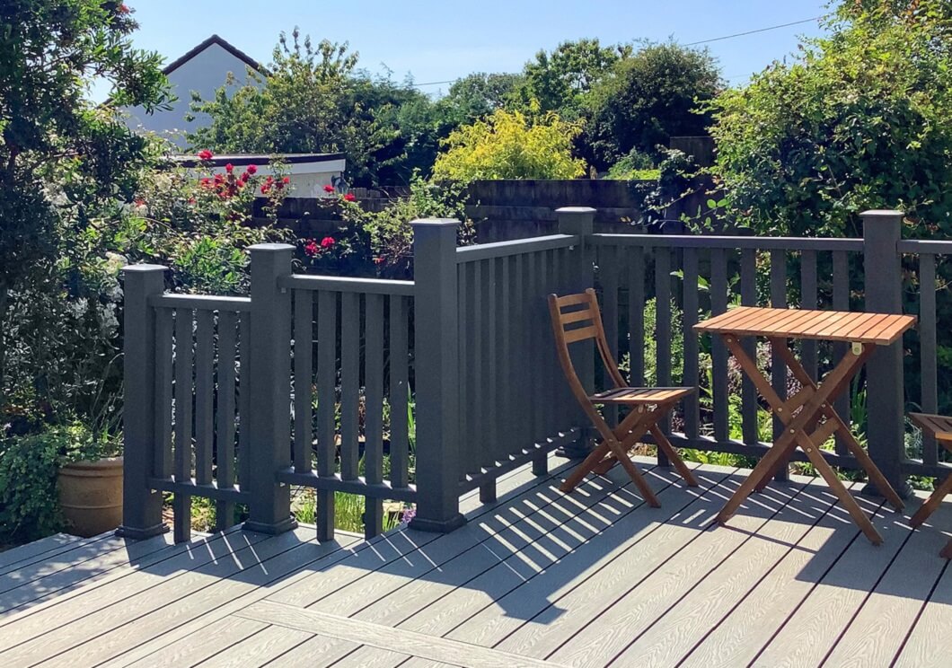 Wooden Balustrade installed around Cladco Composite Woodgrain Stone Grey Decking Boards