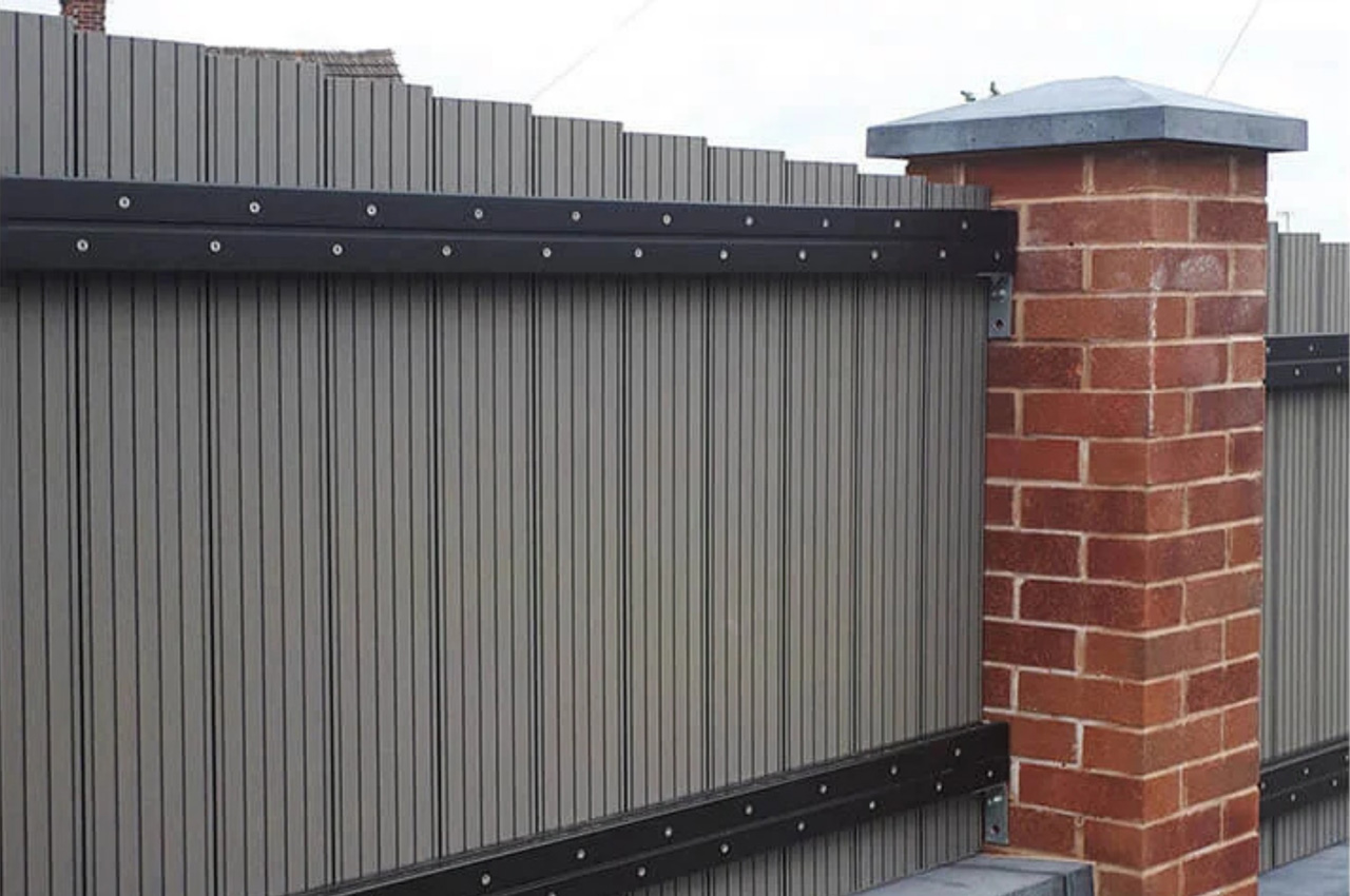 Cladco Woodgrain Composite Decking Boards have been installed as vertical fencing panels around this home