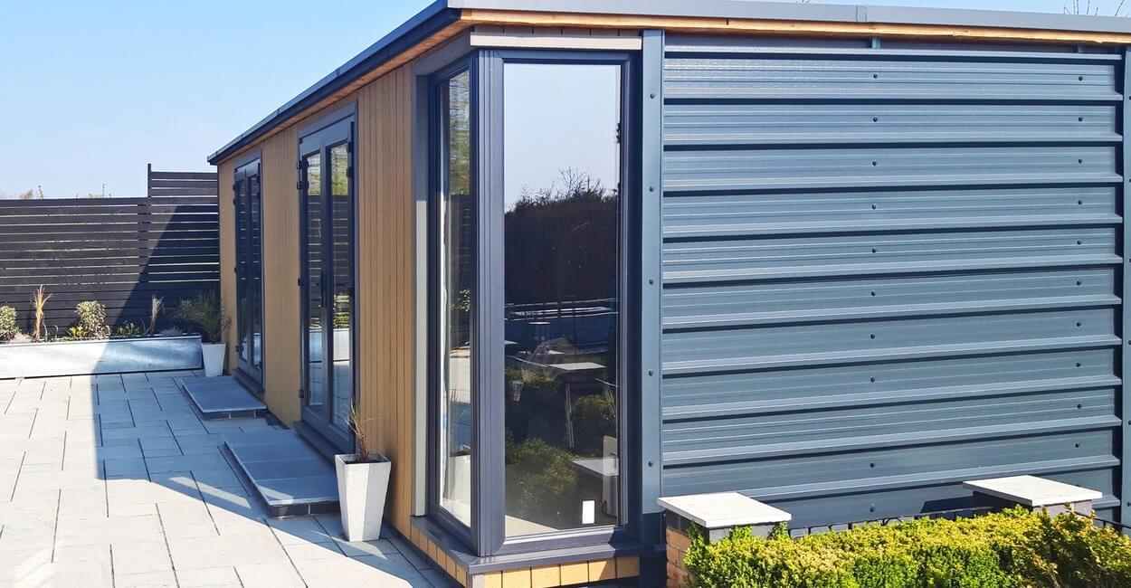 Contemporary garden building features vertical Composite Wall Cladding in Teak