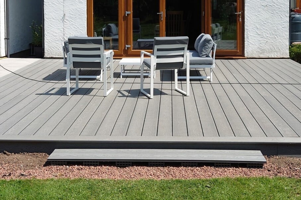 Cladco Woodgrain Composite Decking in Light Grey in this sunny garden location 