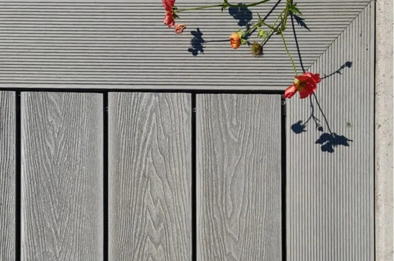 Cladco Woodgrain Composite Decking in Light Grey in this sunny garden location 