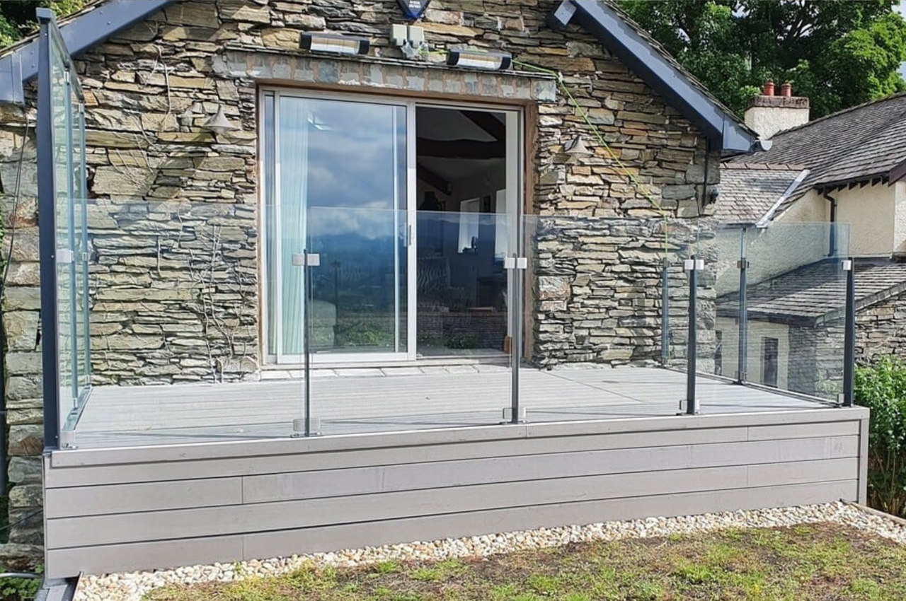 Stone Grey Raised Decking encircles this traditional stone wall cottage.