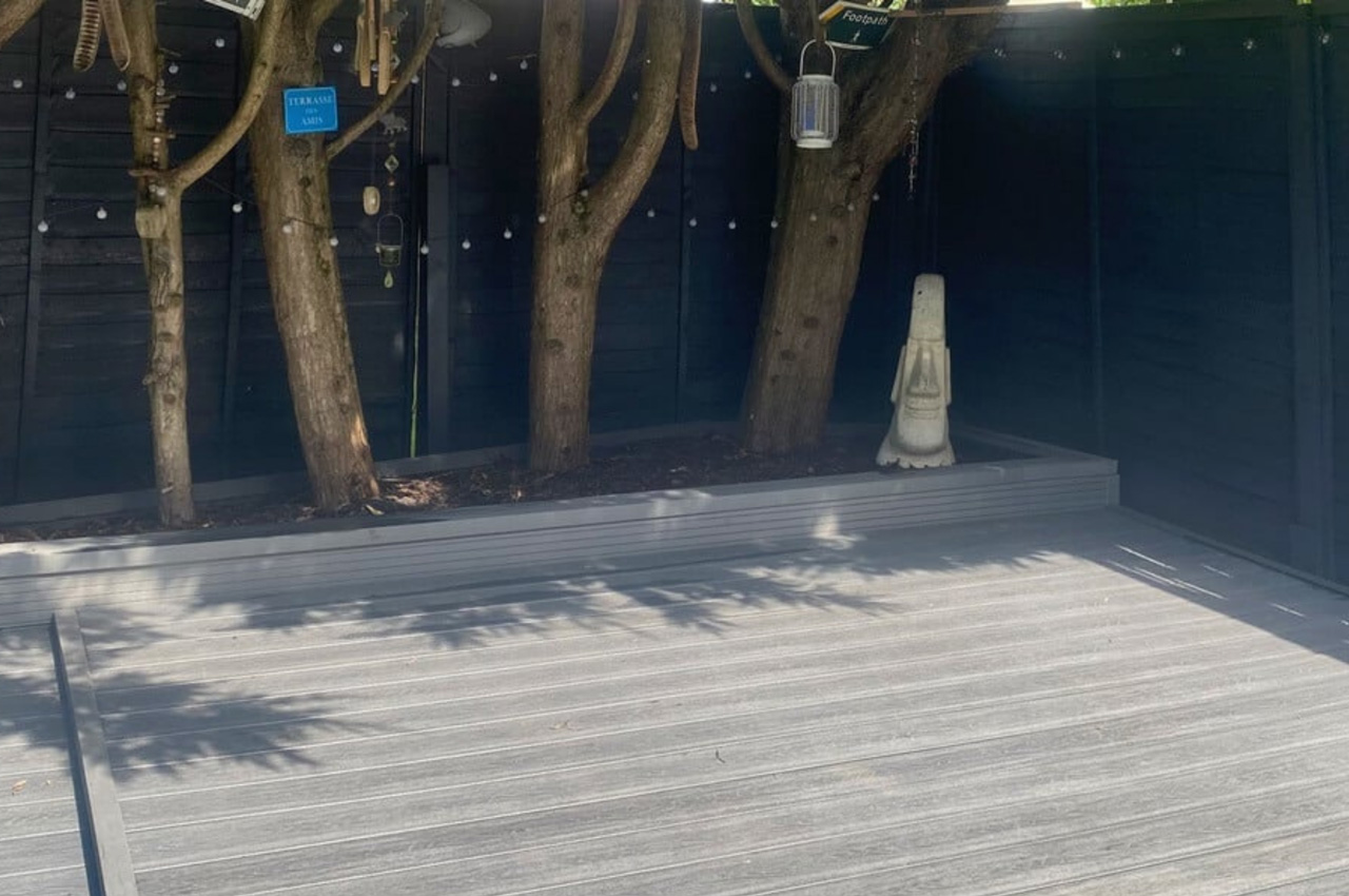 Cladco Composite Woodgrain Boards in Stone Grey make for a relaxing, raised decking in this garden