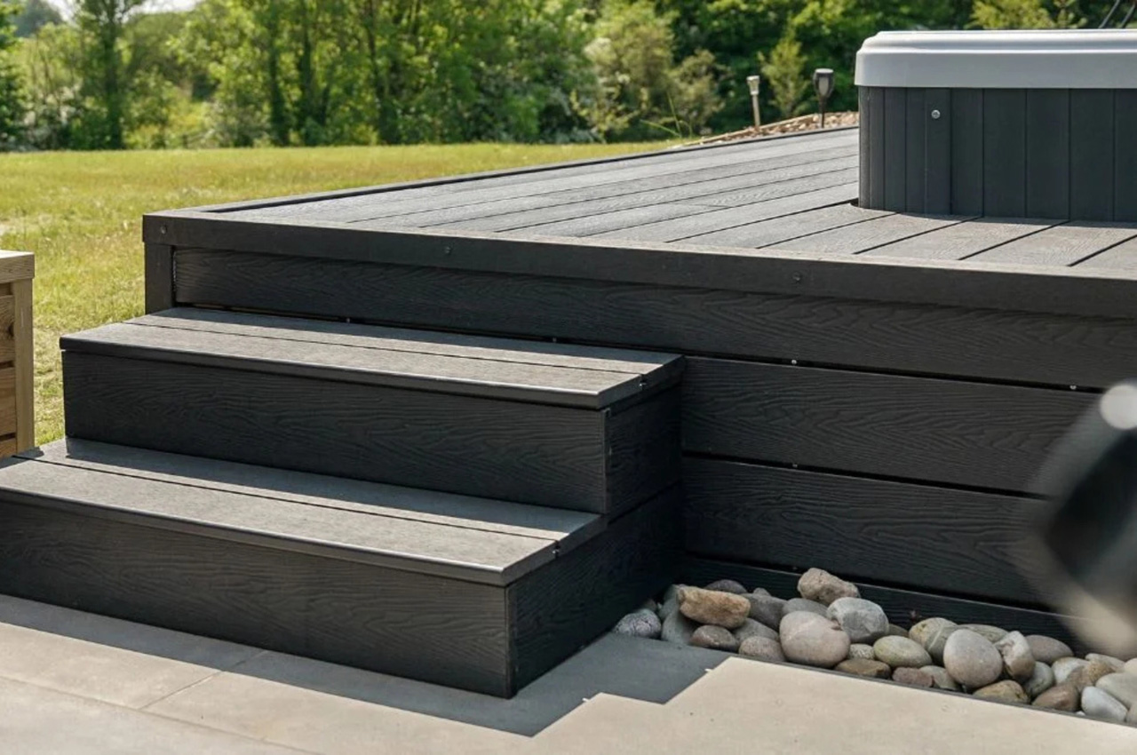 The Black Barn Project uses Cladco Woodgrain Composite Decking in Charcoal for an outdoor hot tub area.
