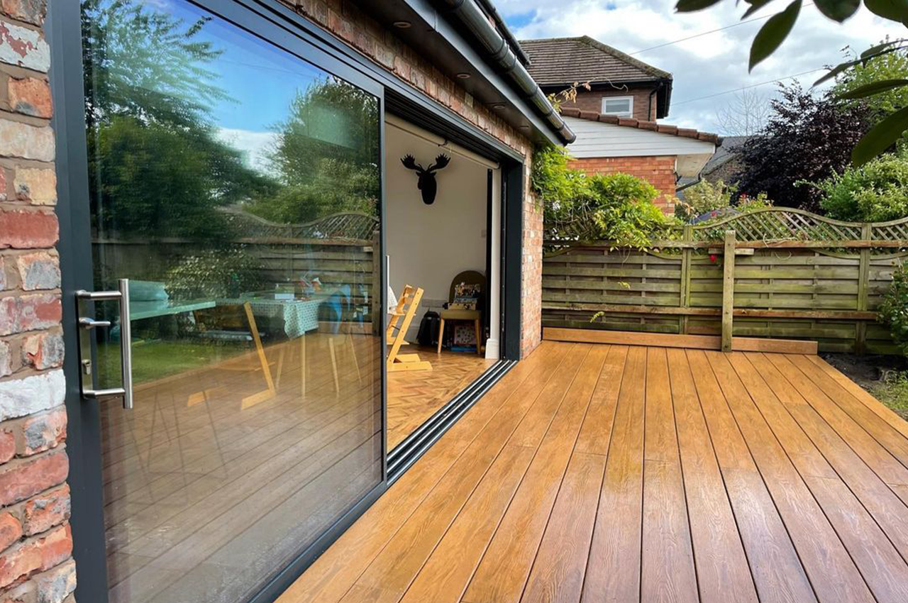 Chestnut Premium PVC Decking area extending from bifold doors onto garden.