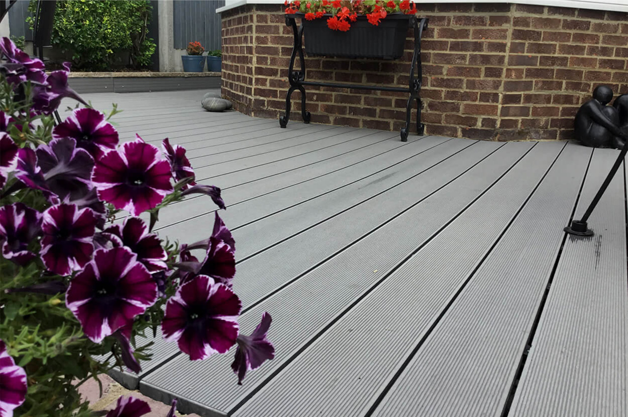 Cladco Composite Decking Boards in Stone Grey with Floral & Stone Boarder