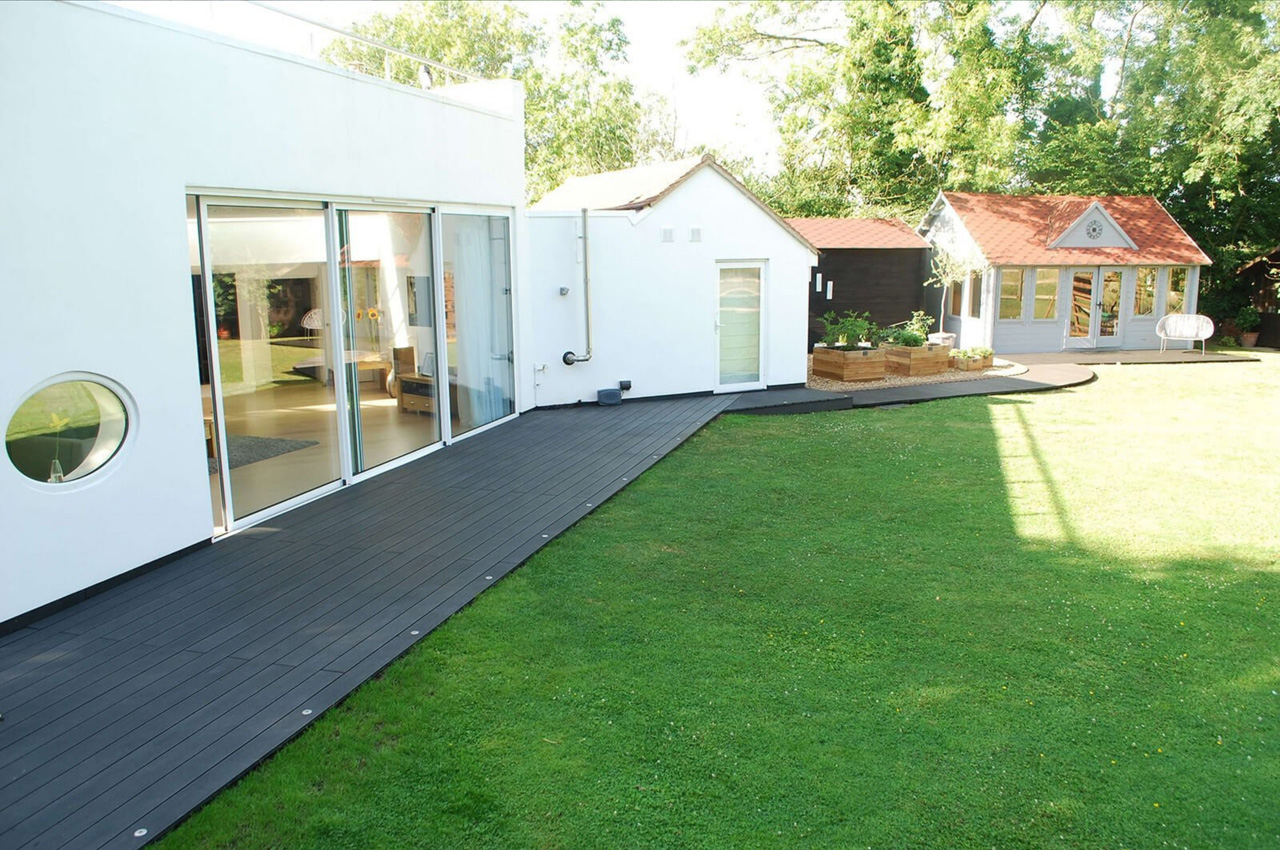 Cladco Composite Decking in Charcoal wraps around a beautiful home