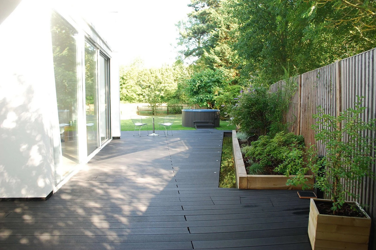 Cladco Composite Decking in Charcoal wraps around a beautiful home