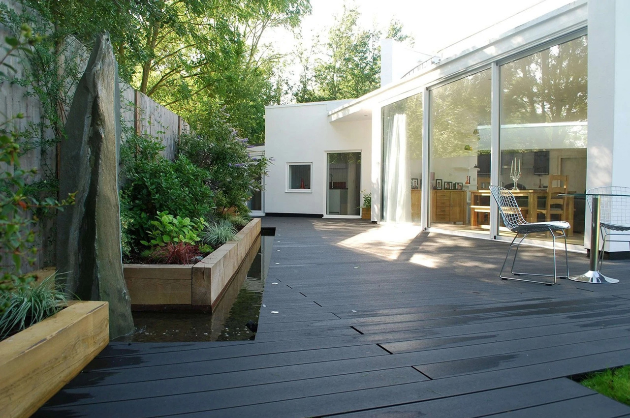 Cladco Composite Decking in Charcoal wraps around a beautiful home