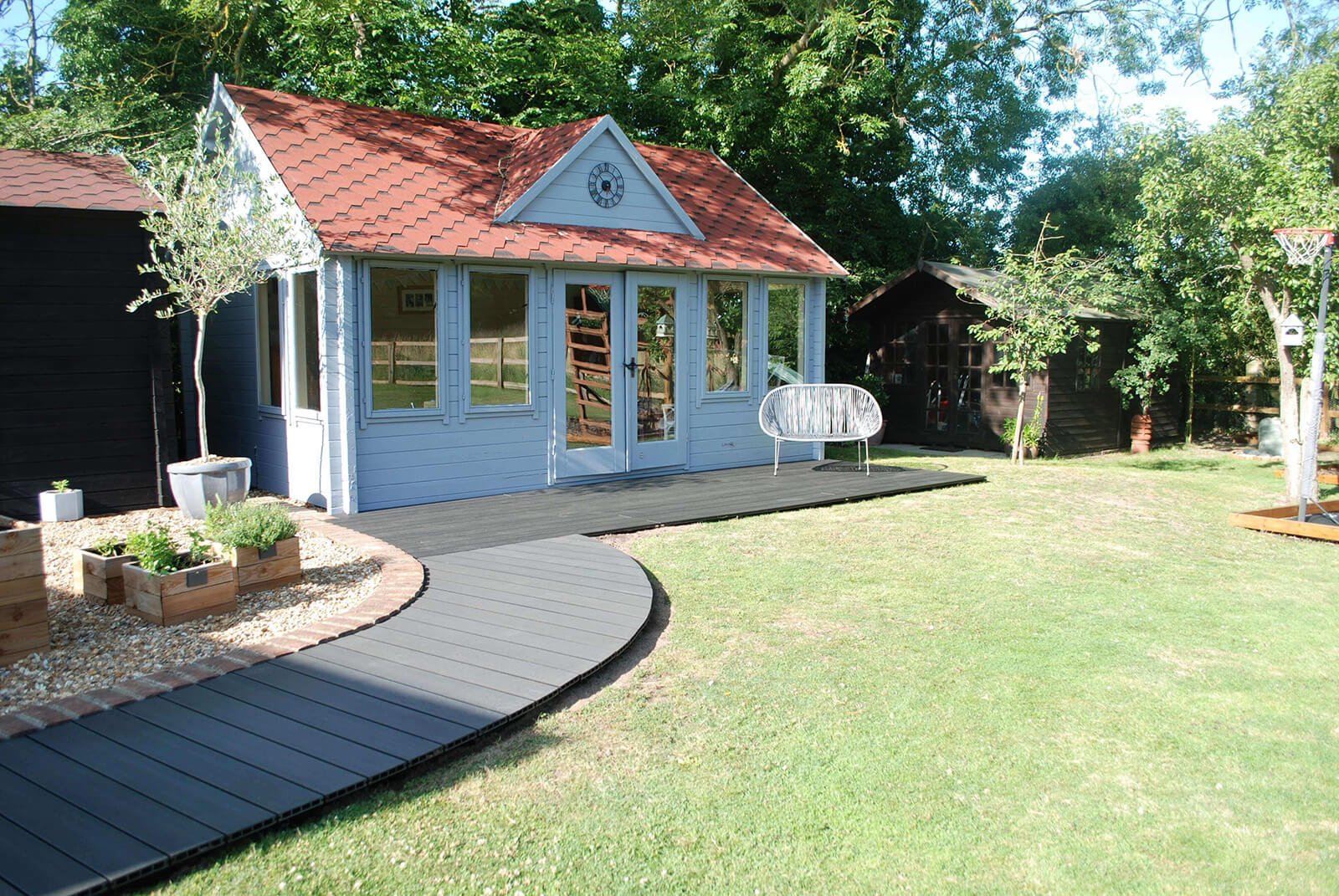 Cladco Composite Decking in Charcoal wraps around a beautiful home