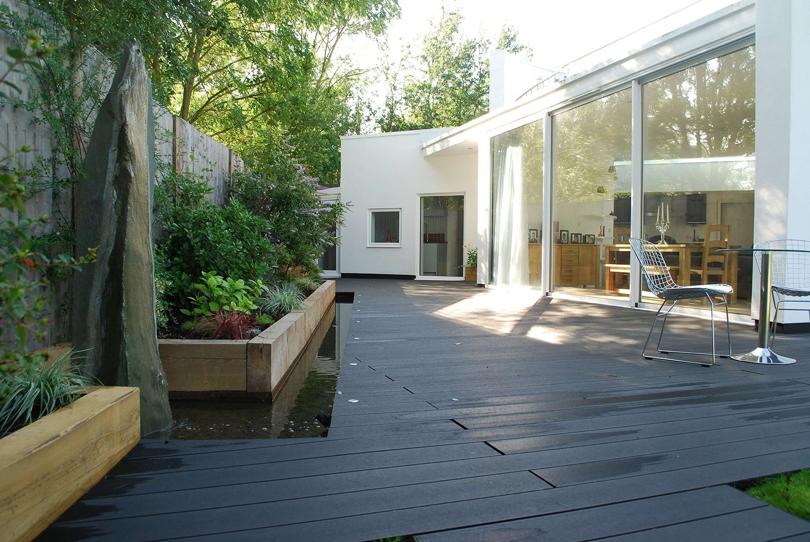 Cladco Composite Decking in Charcoal wraps around a beautiful home