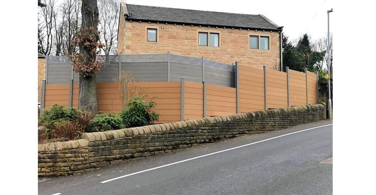 This homeowner selected Cladco Composite Fencing Panels in Teak with Stone Grey Posts 