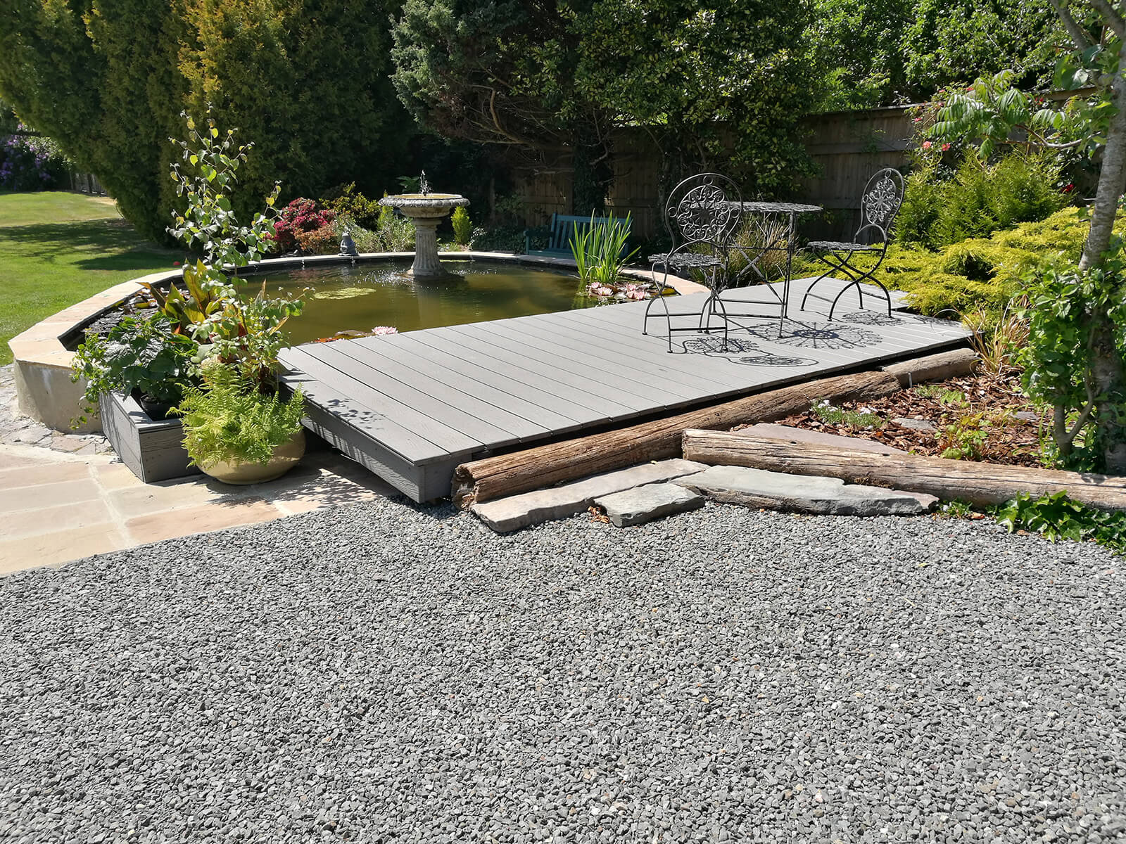 Light Grey Woodgrain Decking by a garden pond and water feature