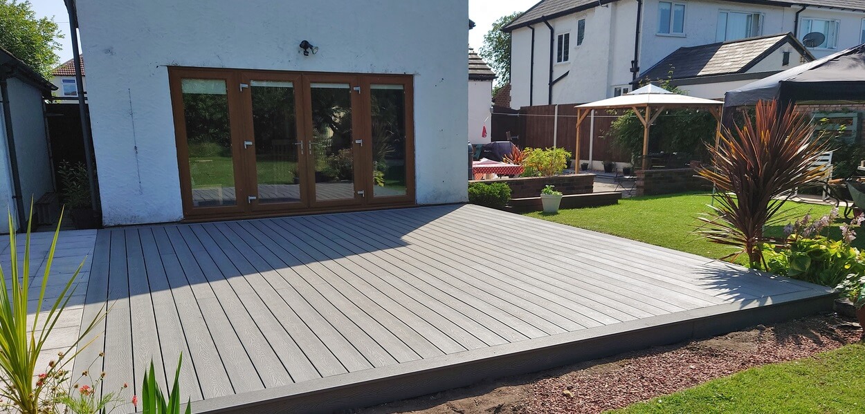 Cladco Woodgrain Composite Decking in Light Grey in this sunny garden location 