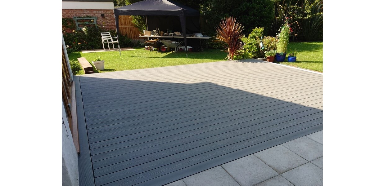 Cladco Woodgrain Composite Decking in Light Grey in this sunny garden location 