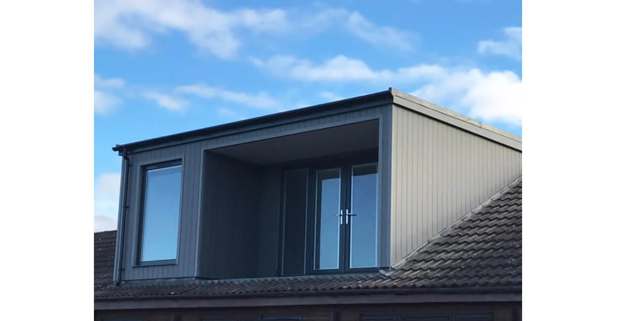 A contemporary dormer window extension uses Cladco Composite Wall Cladding