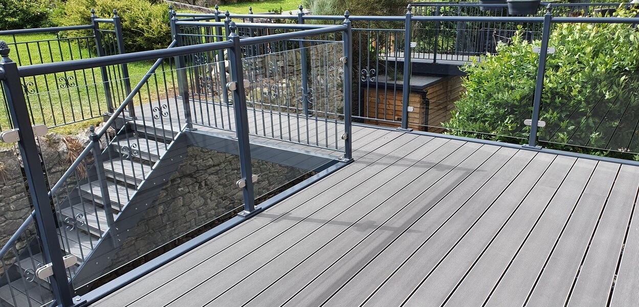 Stone Grey Raised Decking encircles this traditional stone wall cottage.