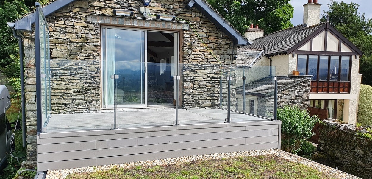 Stone Grey Raised Decking encircles this traditional stone wall cottage.