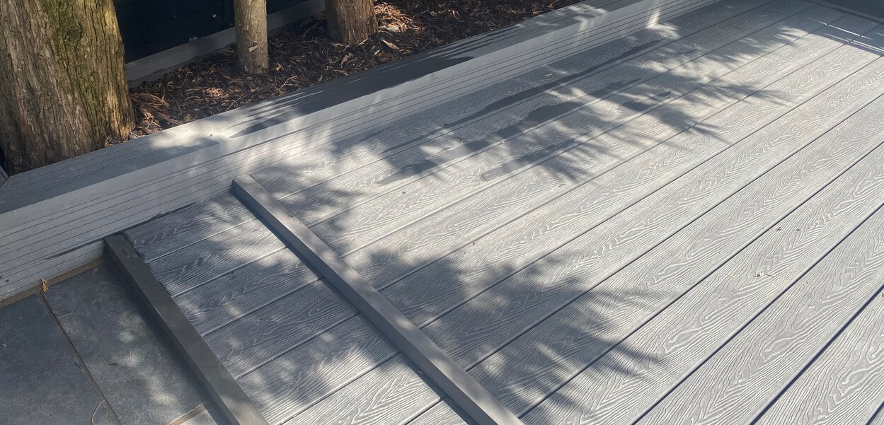 Cladco Composite Woodgrain Boards in Stone Grey make for a relaxing, raised decking in this garden