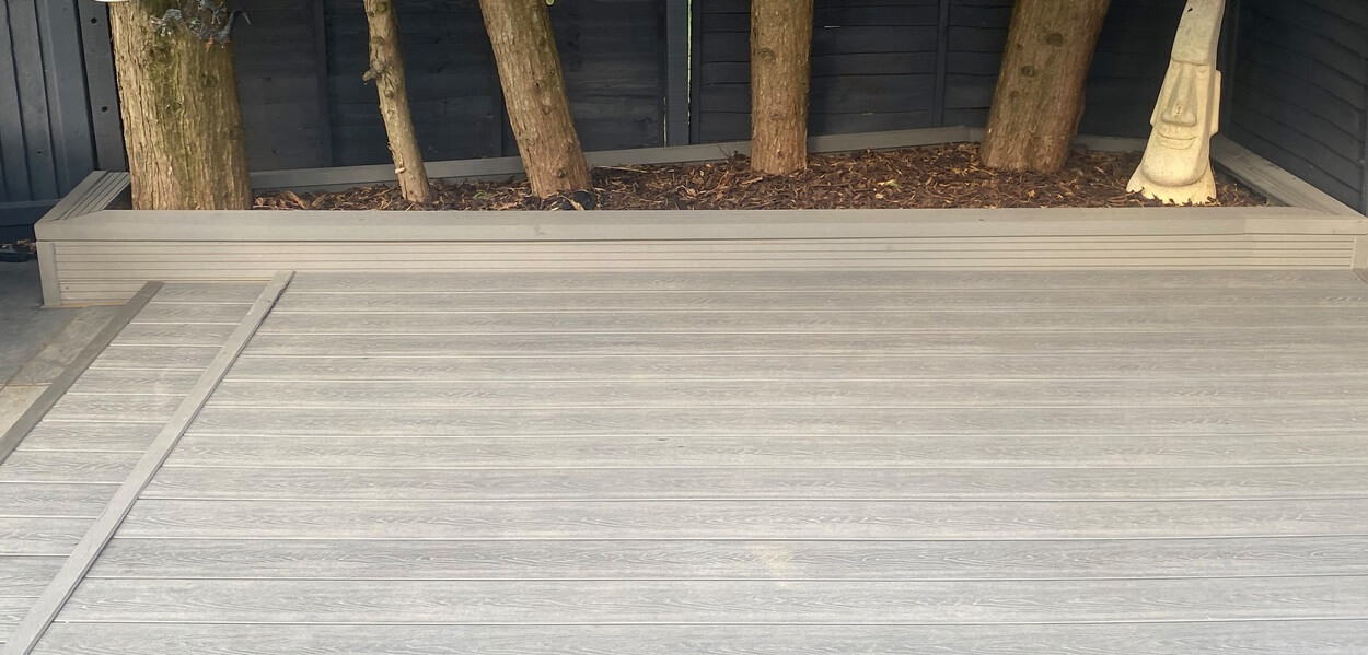 Cladco Composite Woodgrain Boards in Stone Grey make for a relaxing, raised decking in this garden