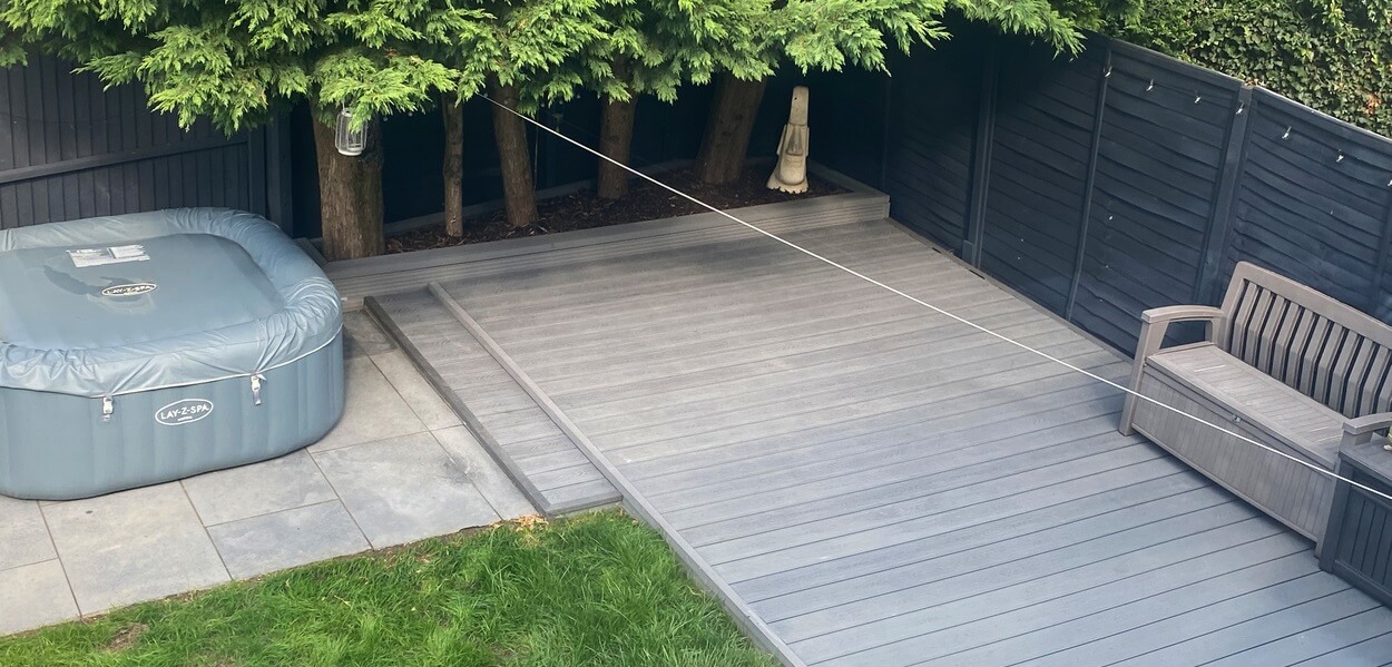 Cladco Composite Woodgrain Boards in Stone Grey make for a relaxing, raised decking in this garden