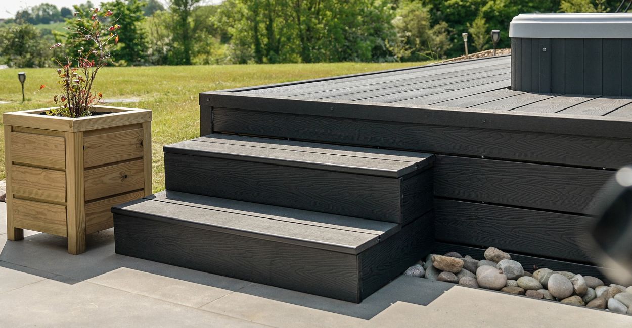 The Black Barn Project uses Cladco Woodgrain Composite Decking in Charcoal for an outdoor hot tub area.