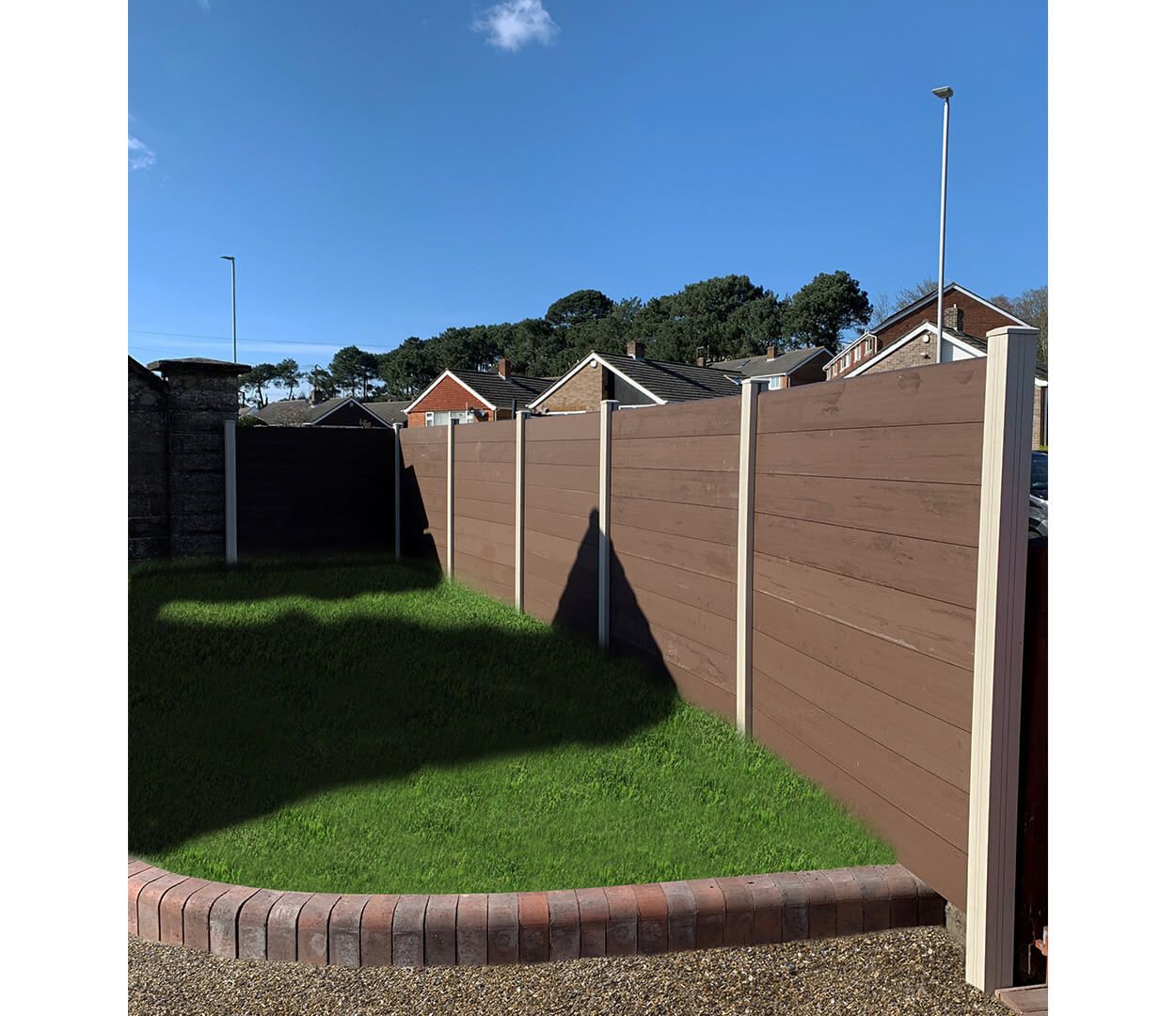 Coffee Fencing Panels contrast Ivory Fencing Posts in this garden