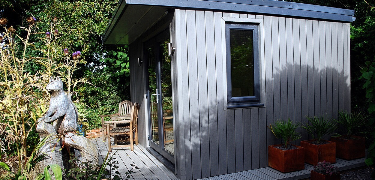 Stone Grey Composite Wall Cladding creates a warm and dry garden retreat.