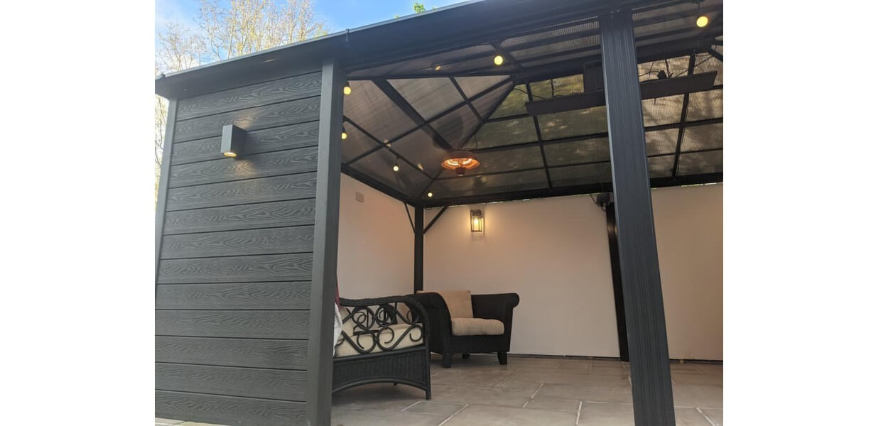 Attractive summer house clad in a sophisticated and contemporary Charcoal Woodgrain Composite Wall Cladding  