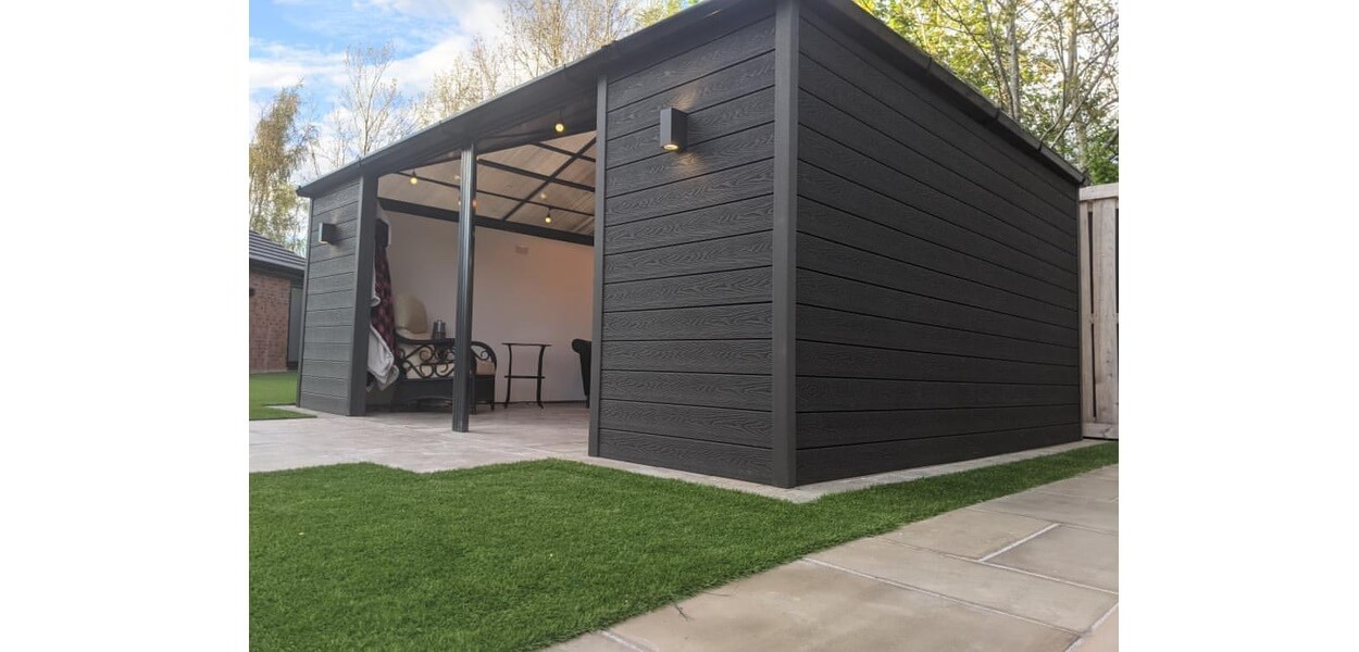 Attractive summer house clad in a sophisticated and contemporary Charcoal Woodgrain Composite Wall Cladding  