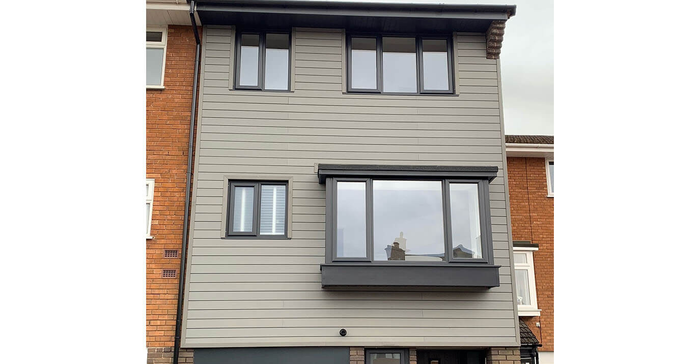 Cladco Stone Grey Composite Wall Cladding Boards modernise an existing semi-detached home.  