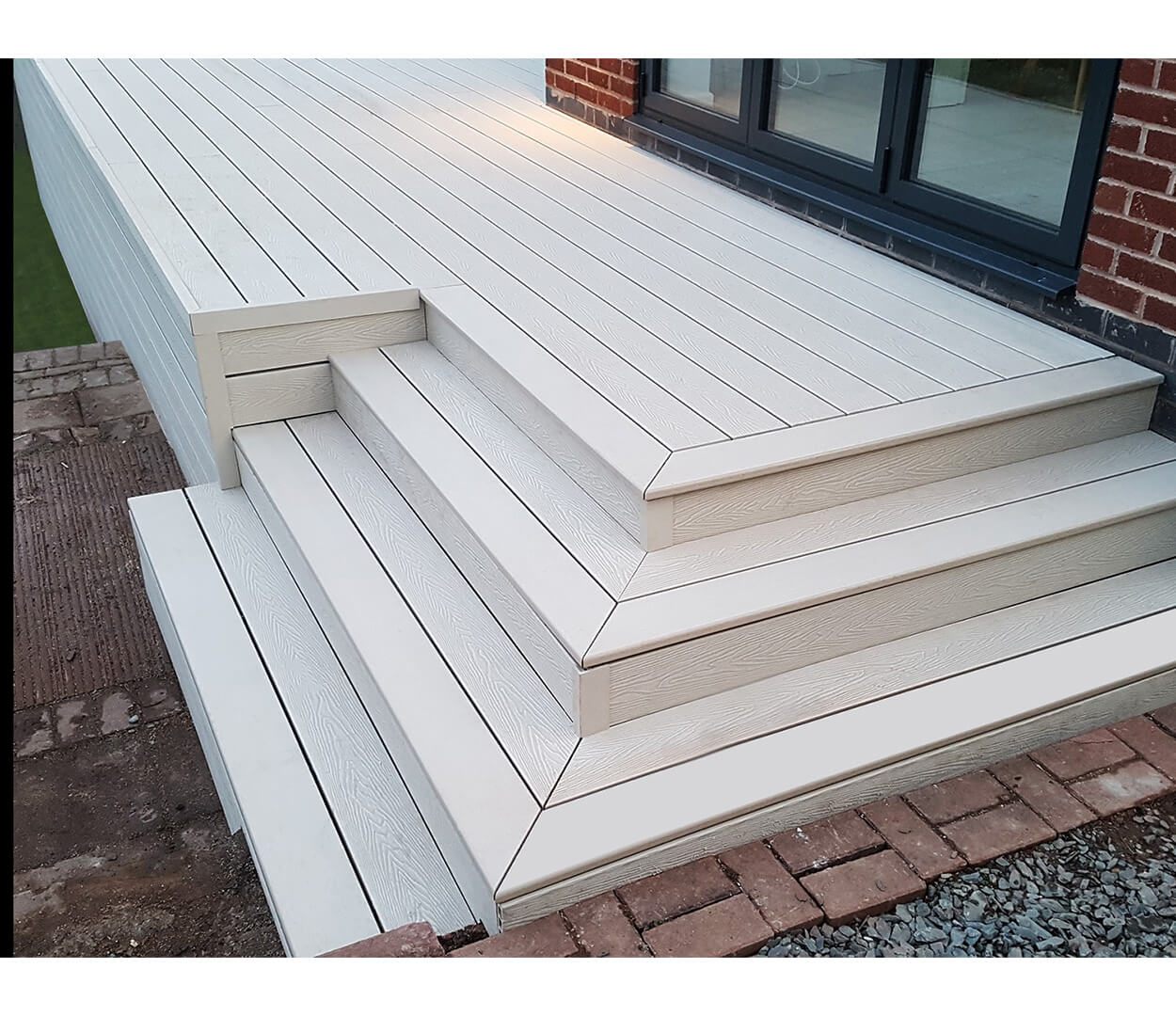 Raised ivory woodgrain decking area with a bullnose edge.