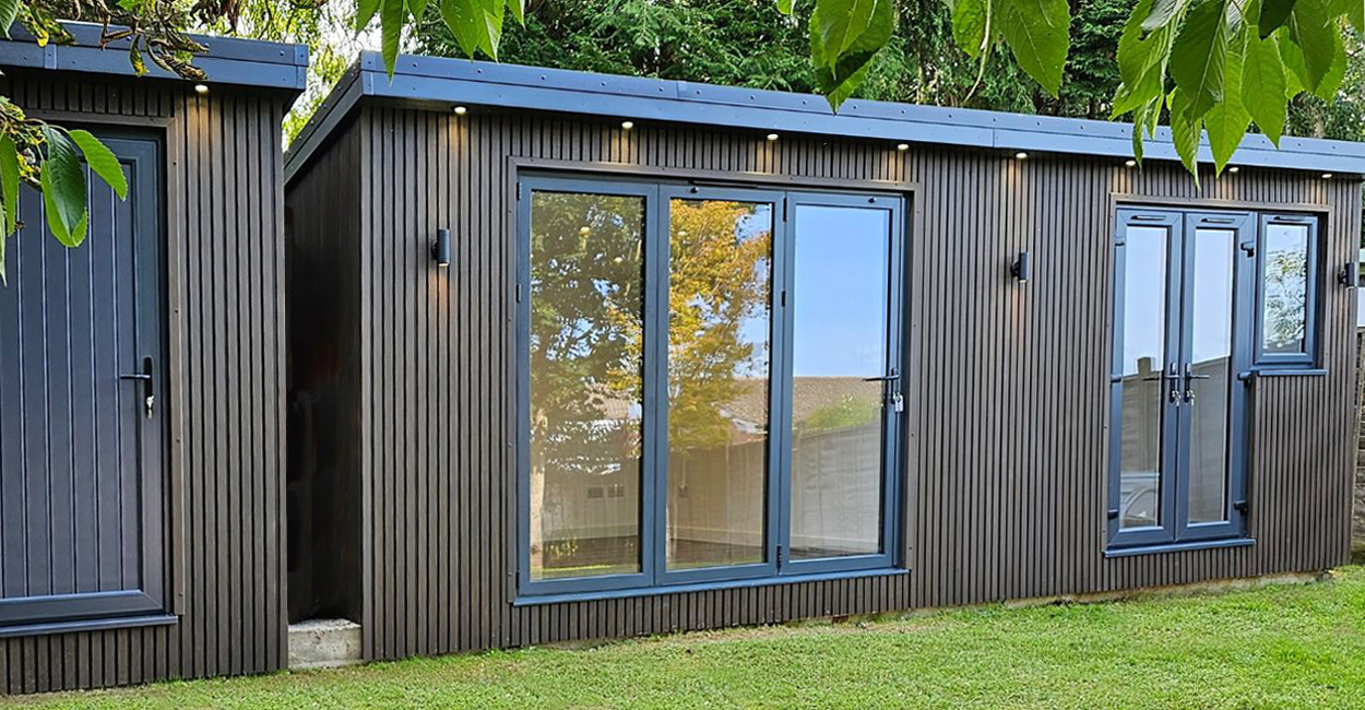 Cladco Composite Slatted Wall Panels in Walnut encase this versatile garden room.