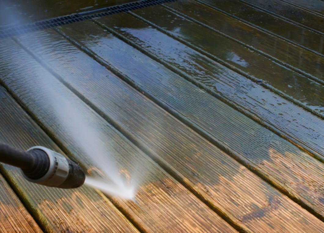 Deck being power washed