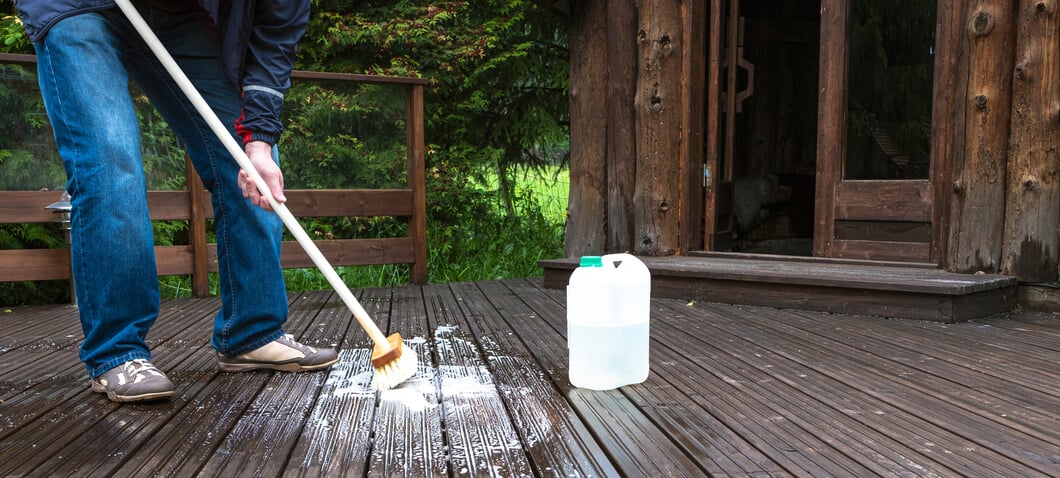 Man cleaning a timber deck