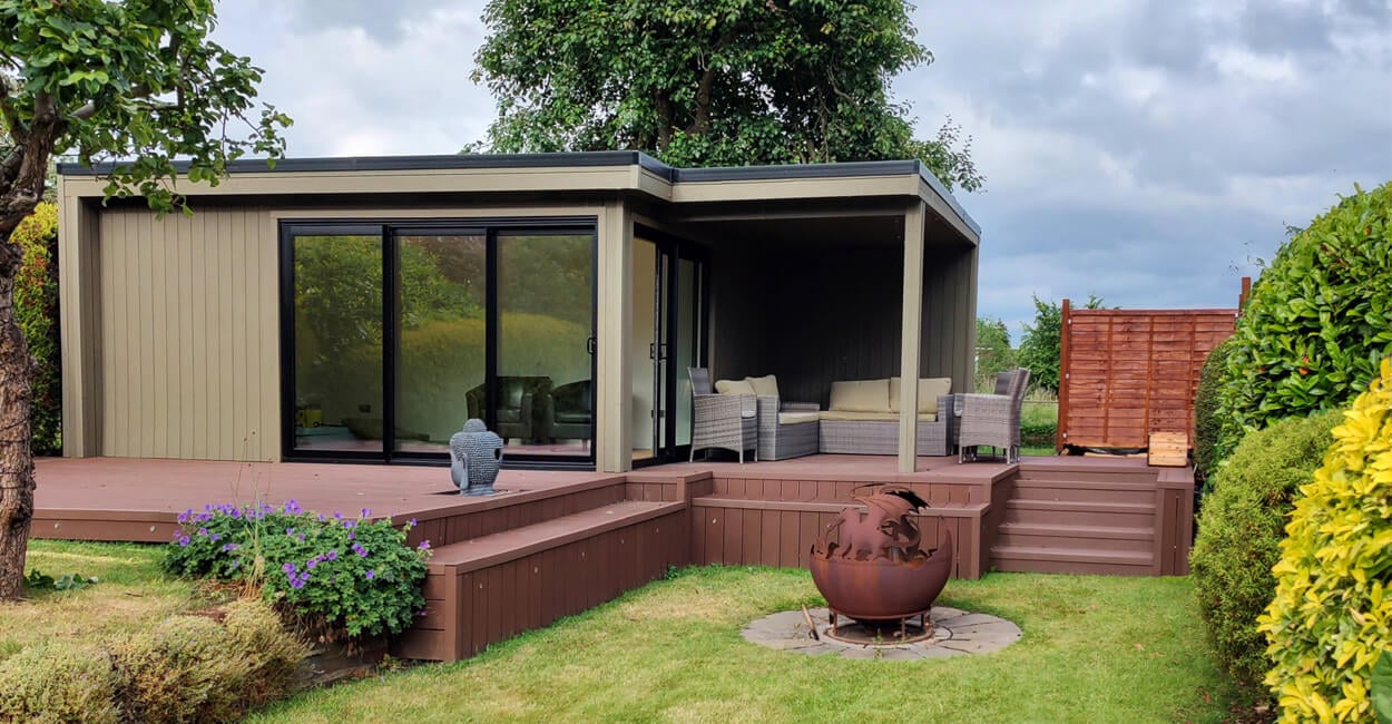 olive green clad garden room with a coffee coloured deck