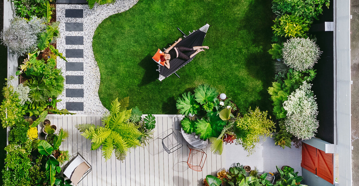 Ivory Composite Decking Boards installed in this plant-filled garden