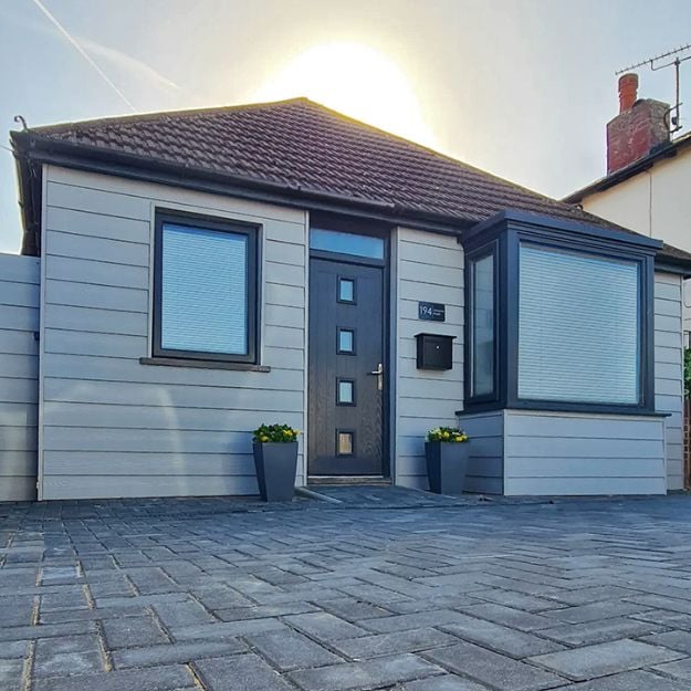 This light and airy garden room as been finished with Fibre Cement Wall Cladding in light grey