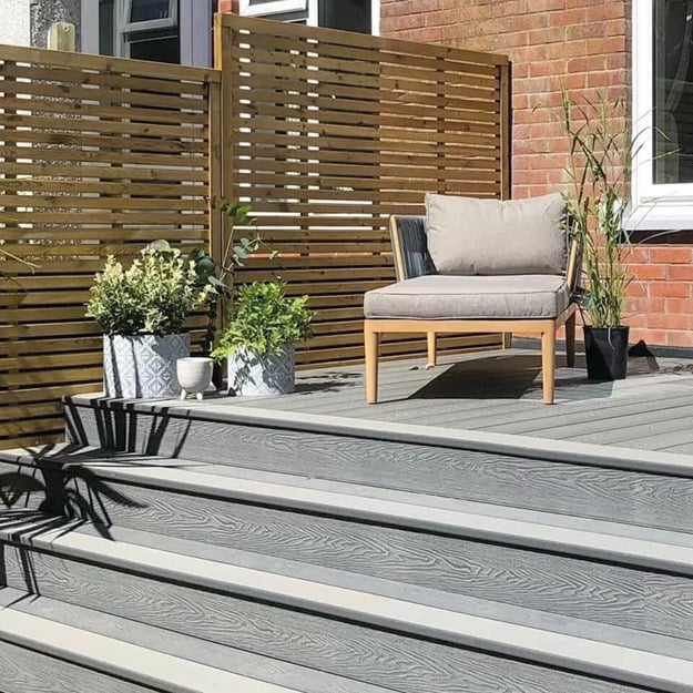 Woodgrain effect composite decking boards with steps leading to a seating area