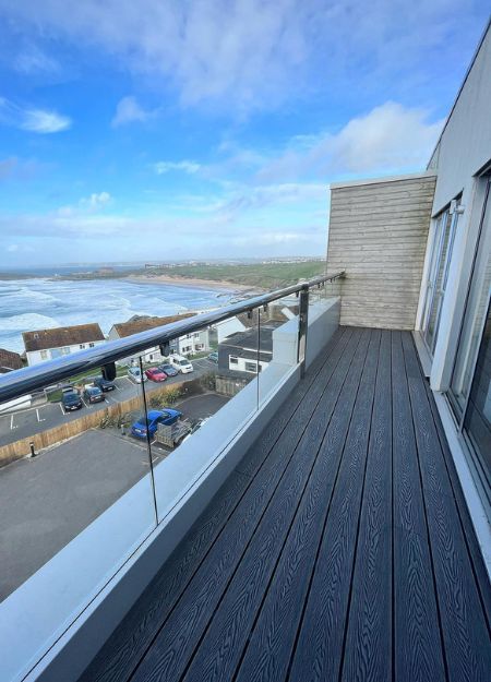 Small balcony with grey woodgrain decking