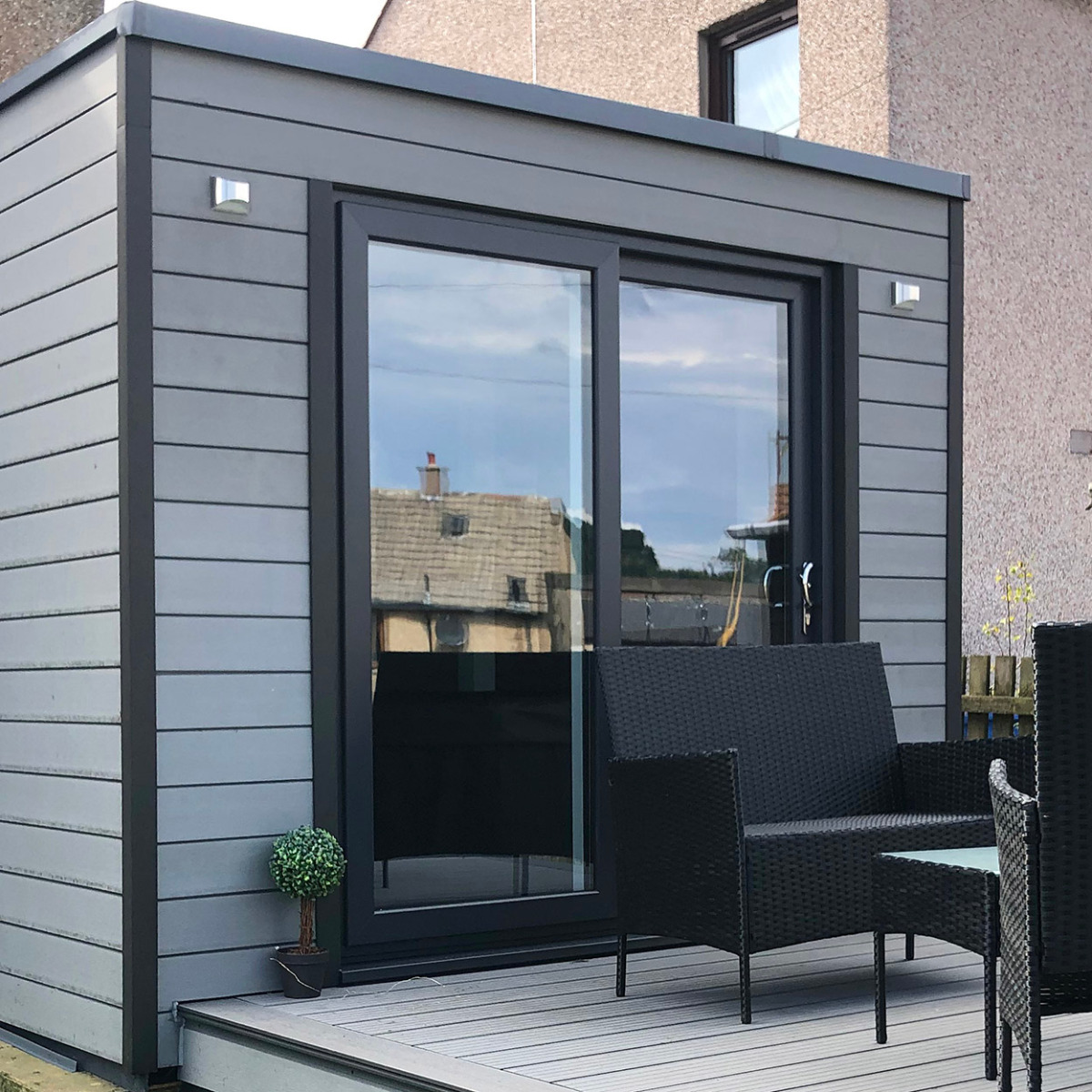 A Stone Grey garden room paired with light grey Decking