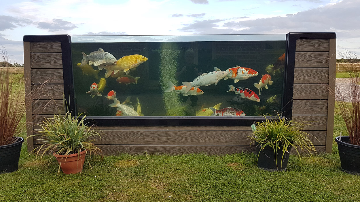A koi fish pond has been finished on the exterior with Composite Wall Cladding for a unique garden project.