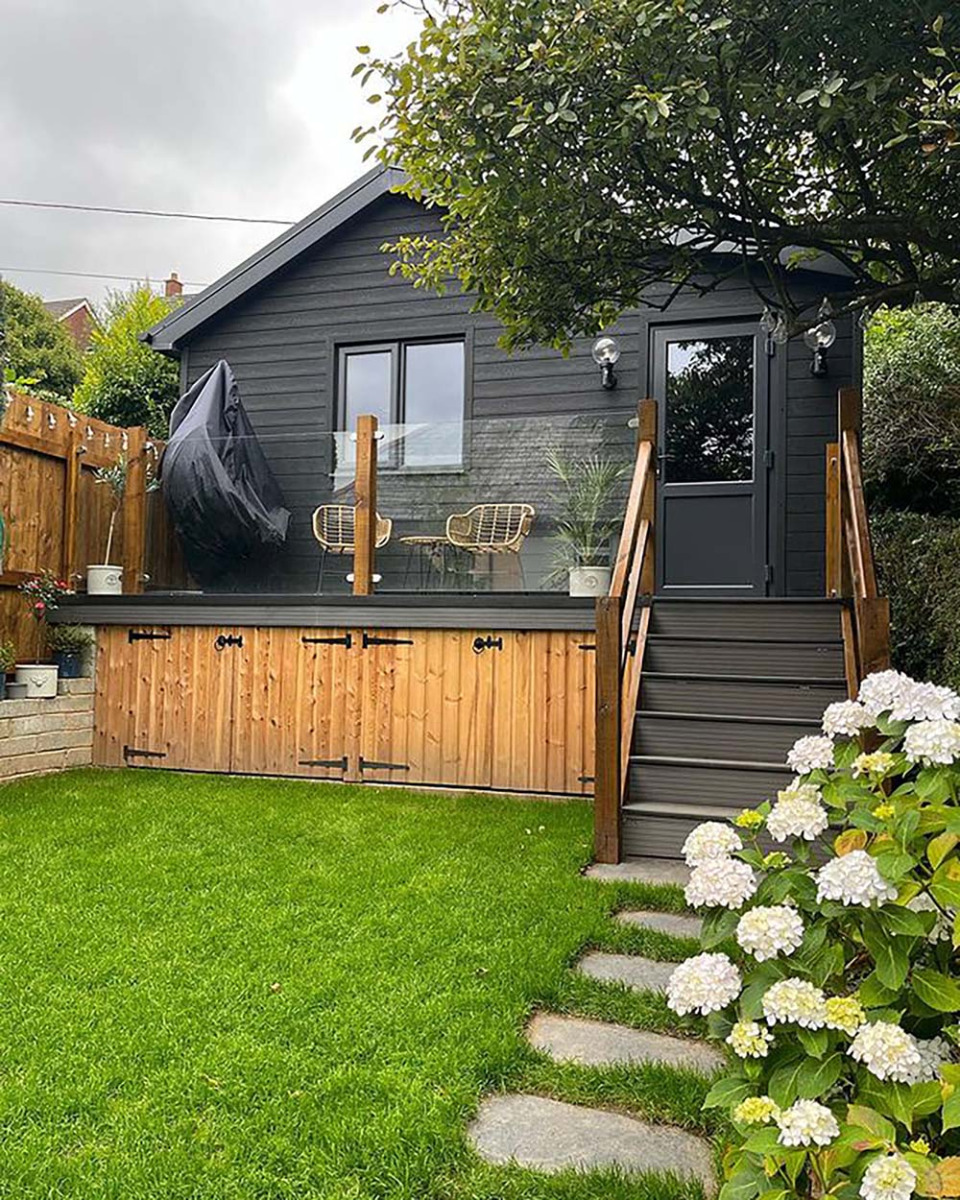A large garden shed has been transformed into a summerhouse using Cladco Composite Wall Cladding in Charcoal