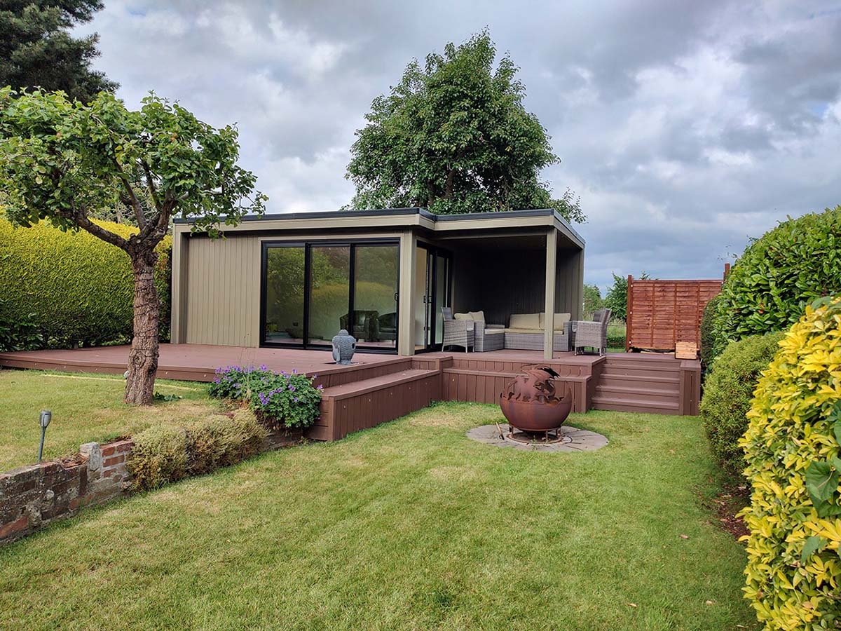Composite Wall Cladding in Olive Green has been paired with Redwood Composite Decking for a large summerhouse and decking project.