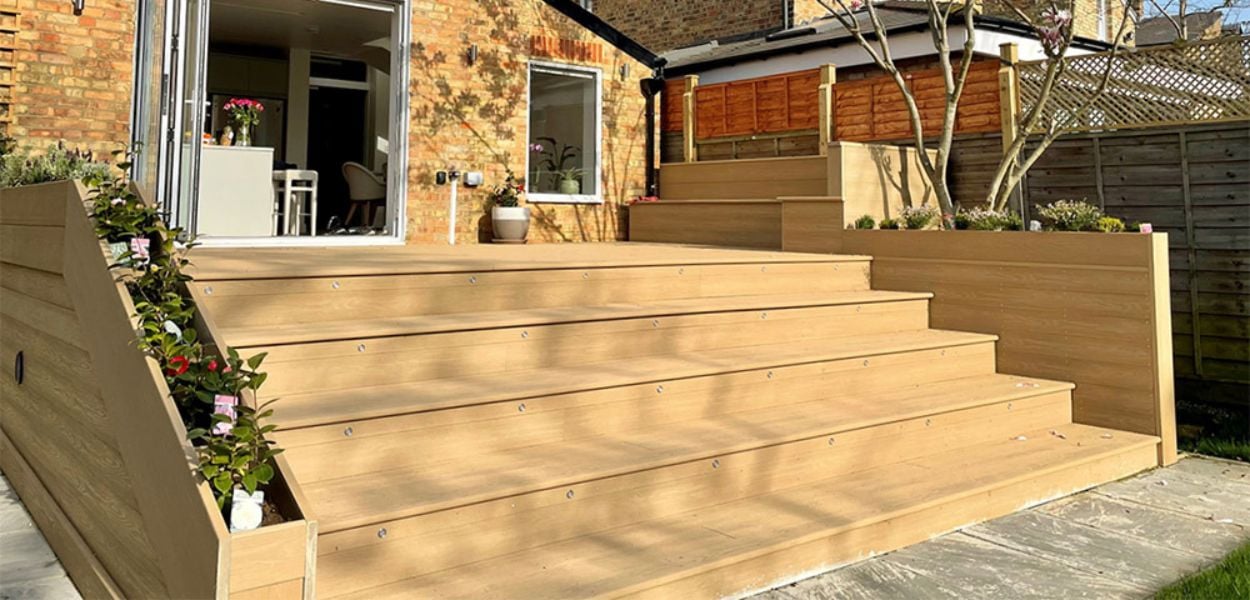 Cladco Premium PVC Decking Steps in the colour Cedar Wood with build in planters for a more unique look