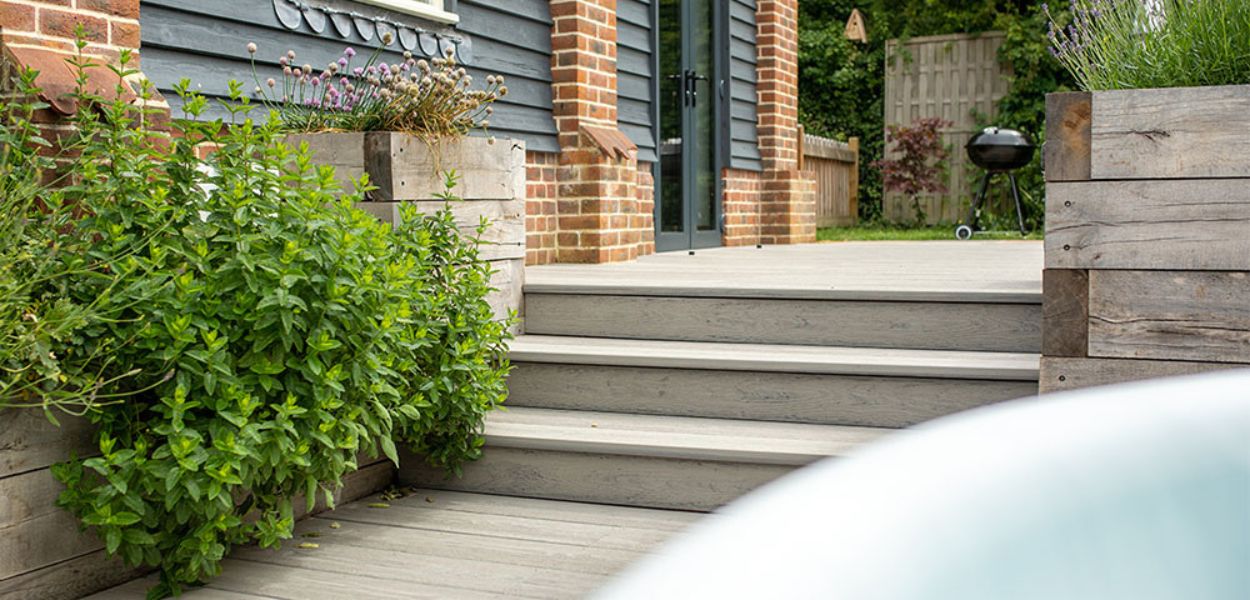 Curved steps deck design: Cladco Premium PVC Bullnose Decking steps in the colour Silver Birch