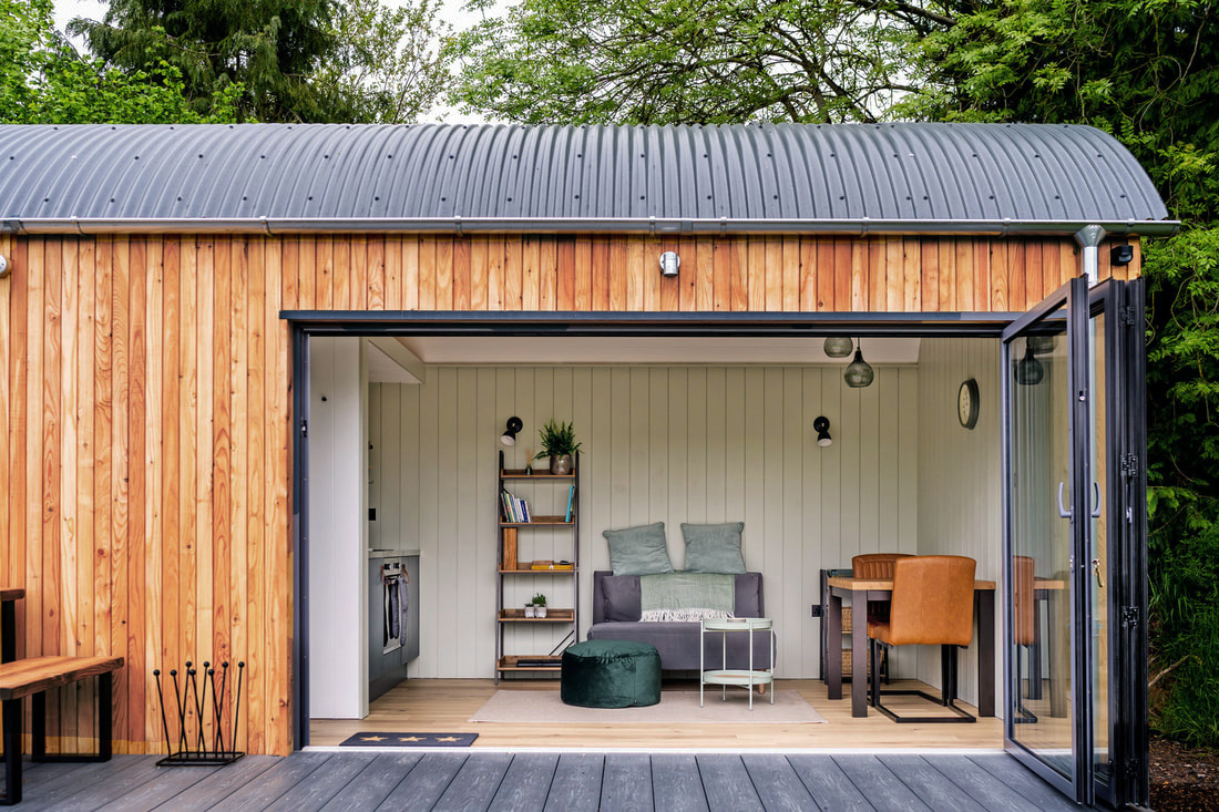 Ash Grey Cladco Premium PVC Decking Boards installed in the garden of a large holiday let.