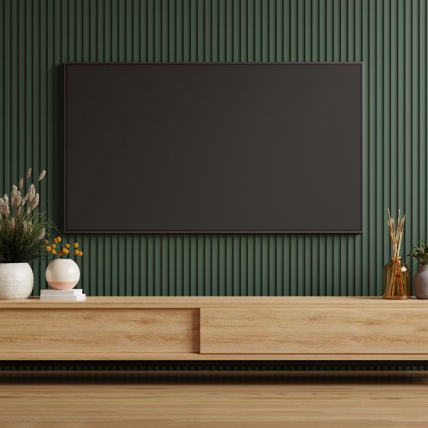 Green painted wood slats installed on a TV wall
