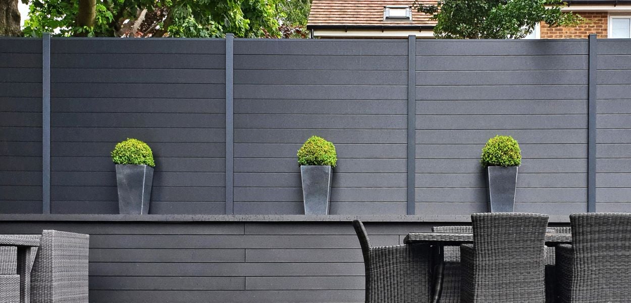 Cladco Composite Fencing in Charcoal with plants on patio